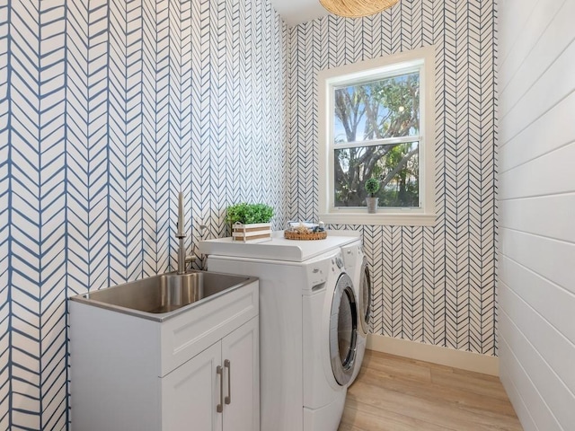 laundry area featuring independent washer and dryer and light wood-type flooring