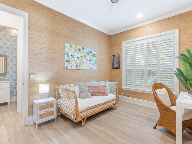 living area with ornamental molding and light hardwood / wood-style floors