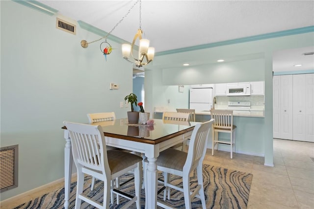 dining space featuring a notable chandelier, visible vents, baseboards, and light tile patterned floors