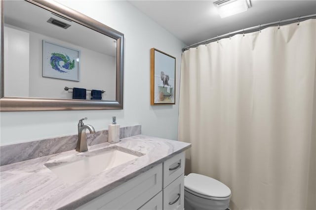 bathroom with visible vents, toilet, and vanity