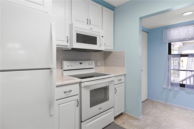 kitchen featuring backsplash, baseboards, light countertops, white cabinets, and white appliances