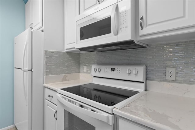 kitchen with decorative backsplash, white appliances, and white cabinets