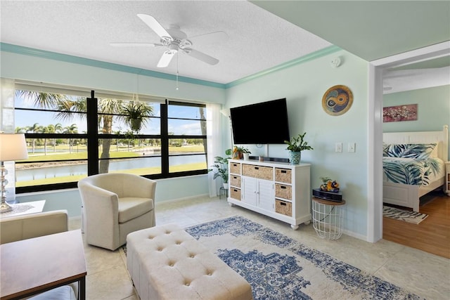 living room with light tile patterned flooring, baseboards, a textured ceiling, and a ceiling fan