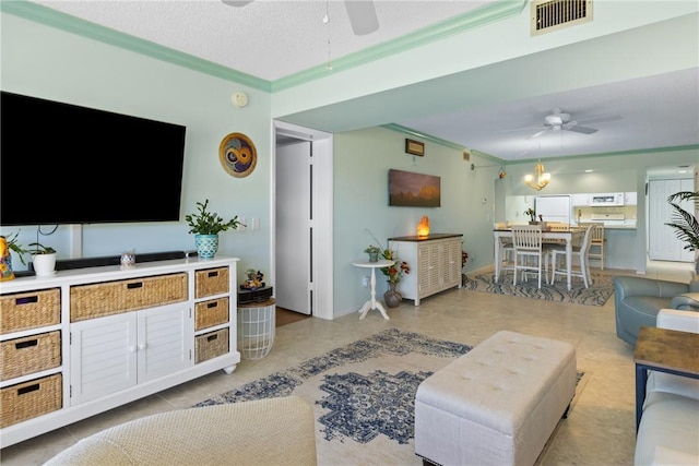 living area with visible vents, a ceiling fan, and crown molding