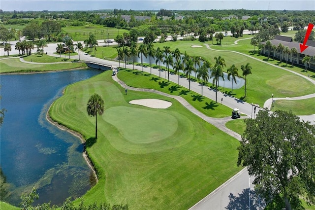 birds eye view of property featuring view of golf course and a water view