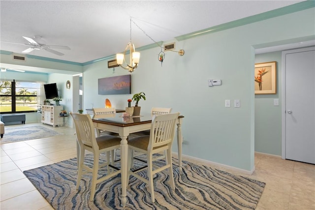 dining space with tile patterned floors, visible vents, ceiling fan with notable chandelier, and baseboards