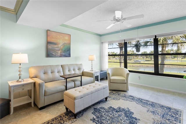 living room featuring a water view, a ceiling fan, a textured ceiling, tile patterned flooring, and baseboards