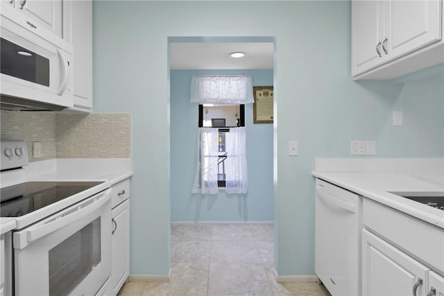 kitchen featuring white appliances, backsplash, white cabinets, and light countertops