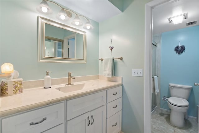 bathroom featuring vanity, a shower stall, toilet, and visible vents