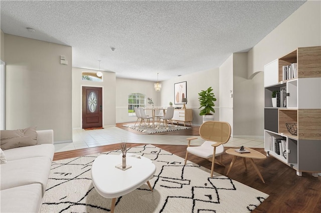 tiled living room with ceiling fan and a textured ceiling