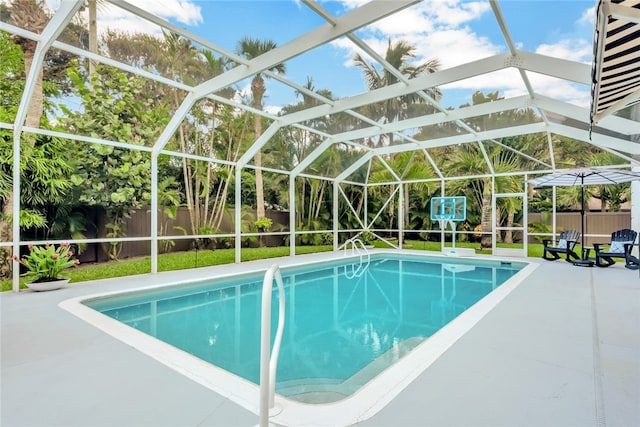 view of swimming pool with a lanai and a patio area