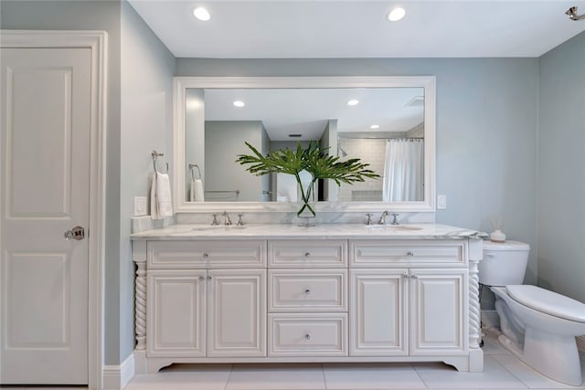 bathroom with vanity, toilet, curtained shower, and tile patterned flooring