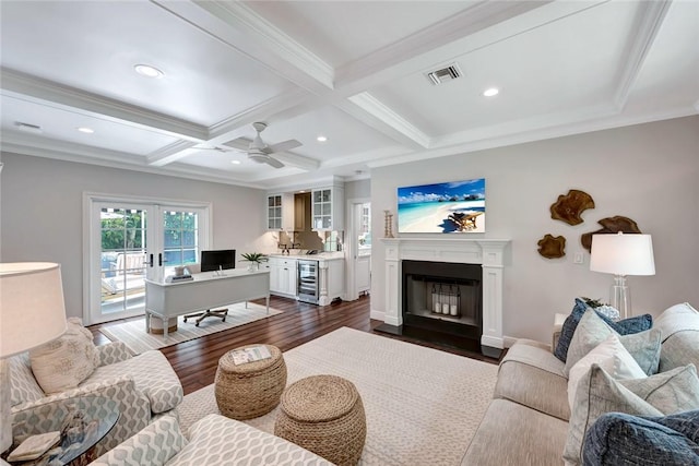 living room featuring dark wood-type flooring, beam ceiling, wine cooler, ornamental molding, and french doors