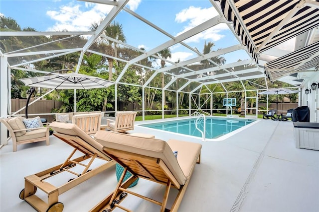 view of swimming pool with outdoor lounge area, glass enclosure, and a patio area