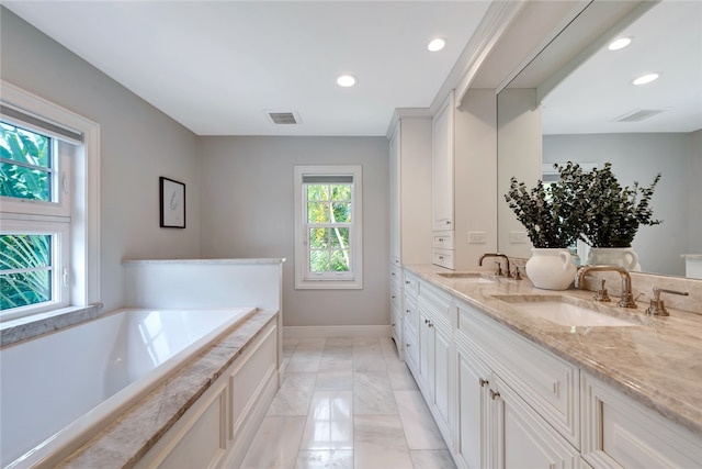 bathroom featuring vanity and tiled tub