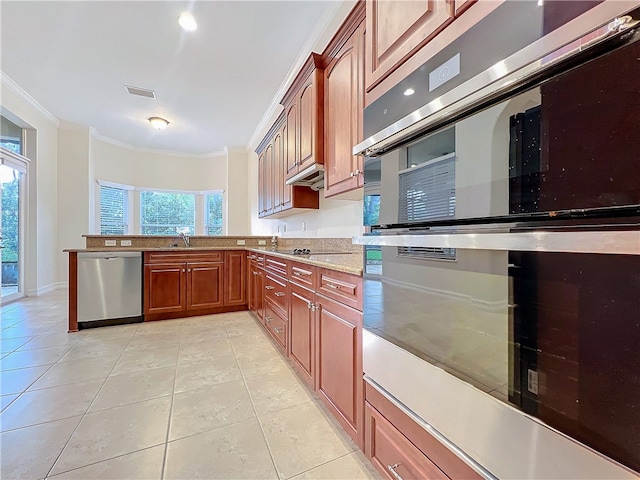 kitchen with light tile patterned floors, stainless steel appliances, visible vents, and crown molding