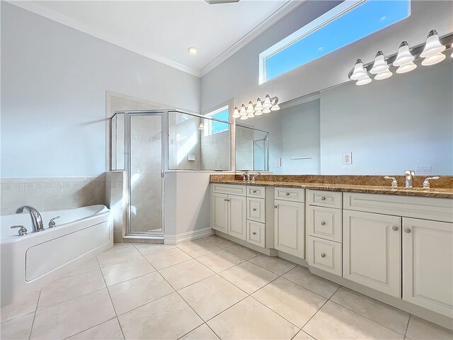 1237 River Reach Dr, Vero Beach, FL 32967 - bathroom featuring tile patterned flooring, double vanity, a shower stall, crown molding, and a garden tub