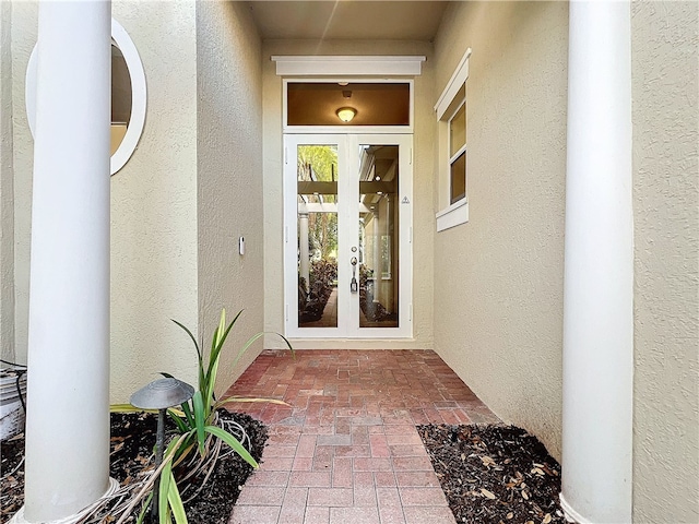 view of front of house with a garage, a front lawn, decorative driveway, and stucco siding