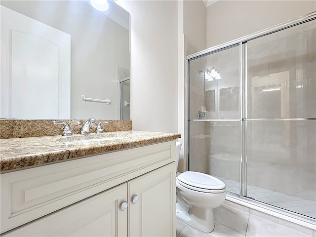 1237 River Reach Dr, Vero Beach, FL 32967 - bathroom with toilet, a stall shower, vanity, and tile patterned floors