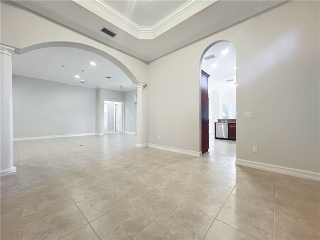 empty room with arched walkways, visible vents, ornamental molding, a raised ceiling, and decorative columns