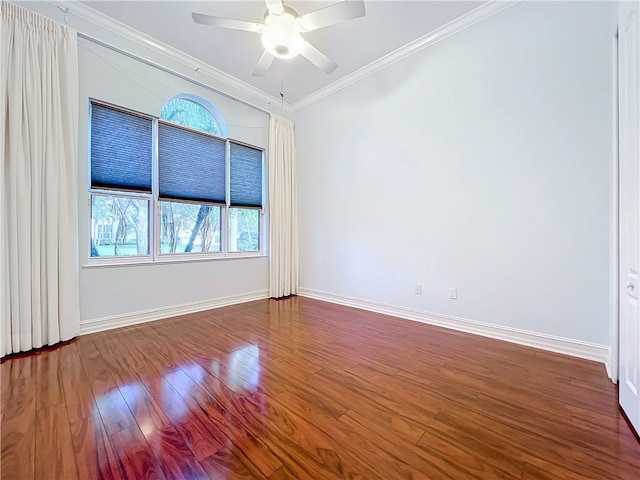 unfurnished room with baseboards, ceiling fan, wood finished floors, and crown molding