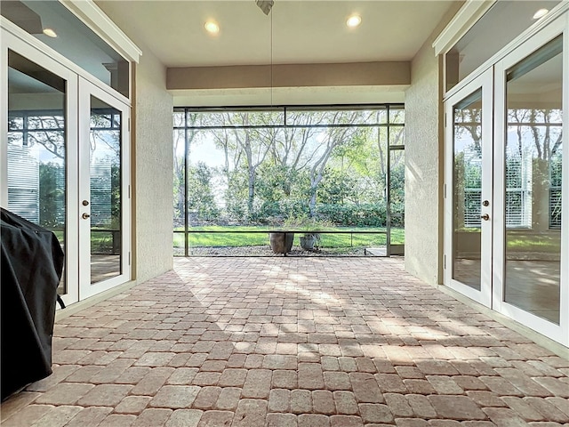 unfurnished sunroom featuring french doors