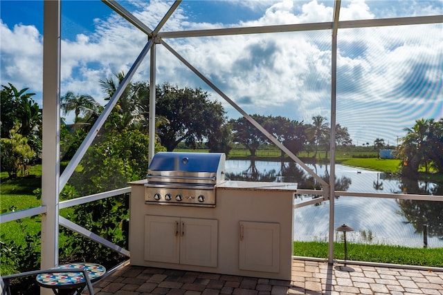 view of patio featuring a lanai, grilling area, a water view, and area for grilling