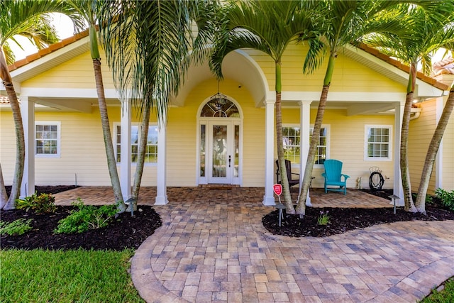 view of exterior entry with a patio and french doors