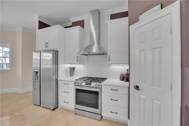 kitchen with white cabinetry, stainless steel appliances, wall chimney range hood, and backsplash