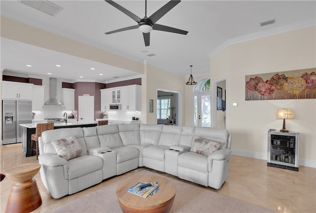 living room with ornamental molding and ceiling fan