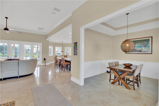 dining room with ceiling fan and ornamental molding