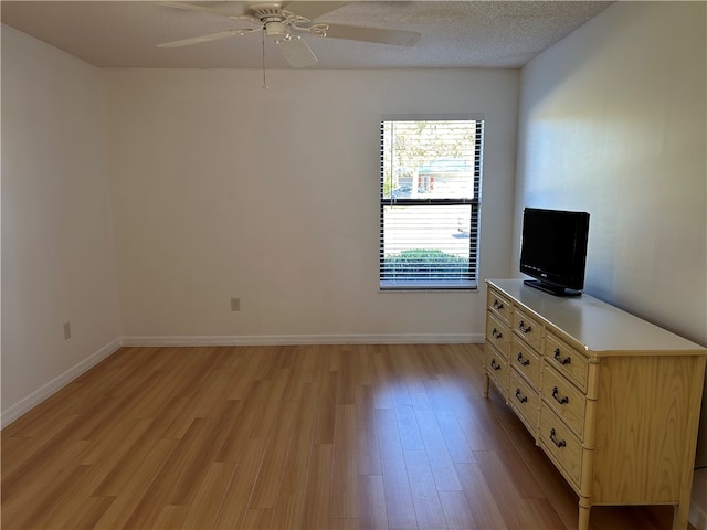 unfurnished bedroom with ceiling fan, light hardwood / wood-style flooring, and a textured ceiling