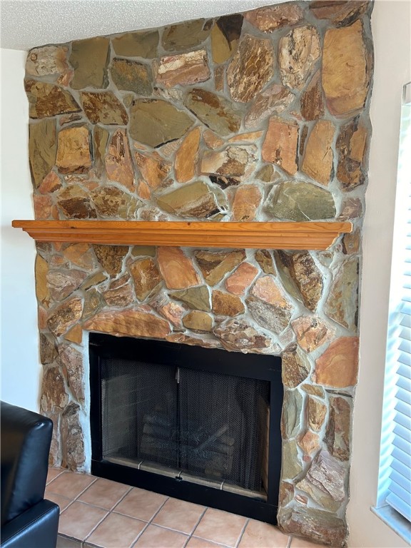 details with a fireplace and a textured ceiling