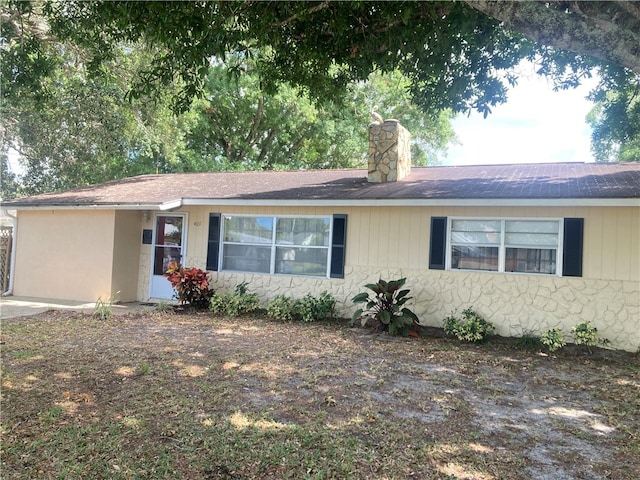 401 Easy St, Sebastian, FL 32958 - single story home featuring a chimney, stone siding, and roof with shingles
