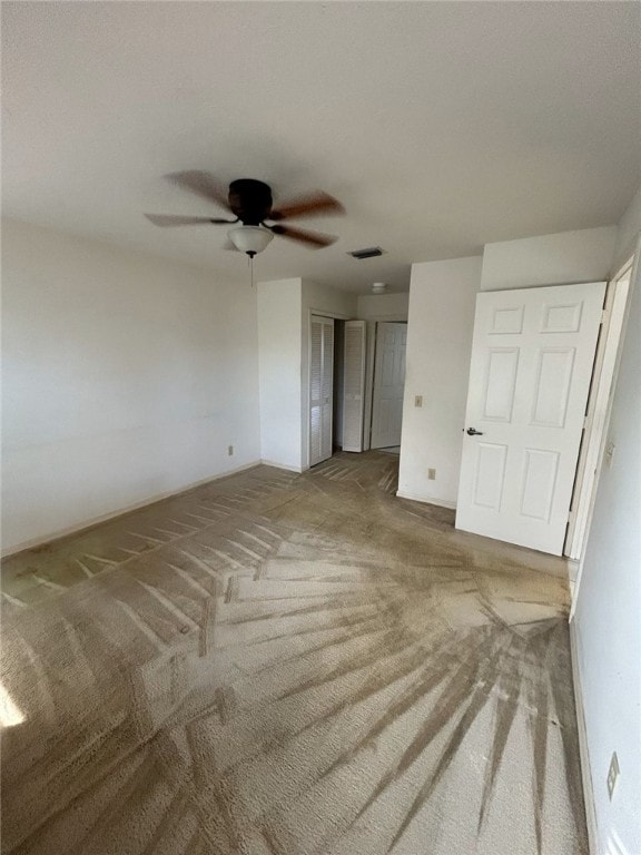 unfurnished room featuring ceiling fan and carpet floors