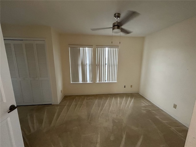 unfurnished bedroom with carpet floors, a closet, and ceiling fan