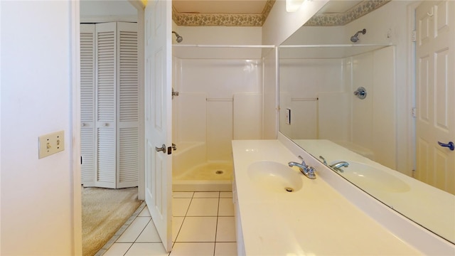 bathroom featuring vanity, tile patterned floors, and walk in shower