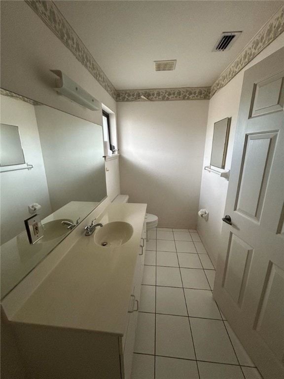 bathroom with tile patterned floors, toilet, and vanity