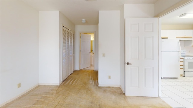 corridor featuring light colored carpet