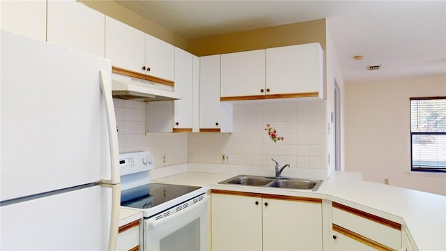 kitchen with white cabinetry, sink, white appliances, and tasteful backsplash