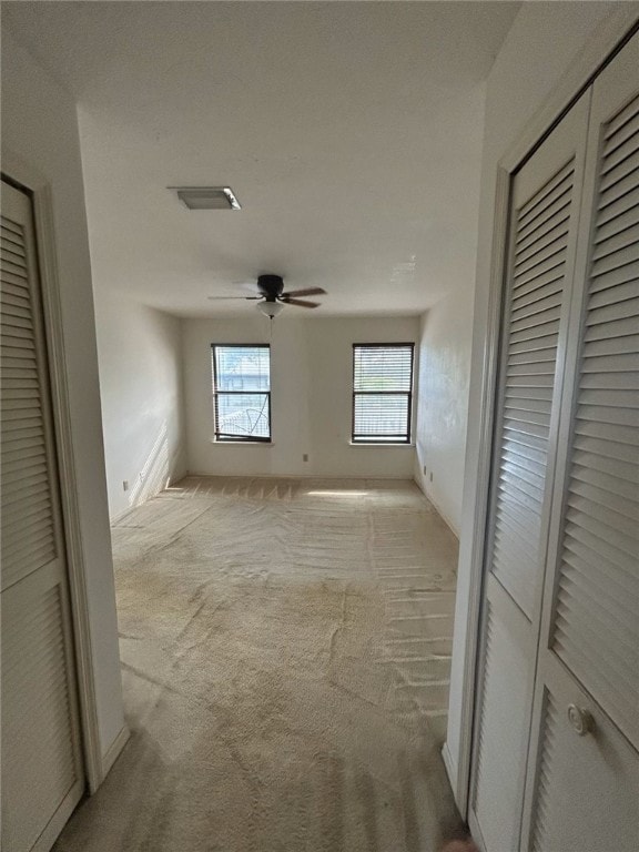 hallway with light colored carpet