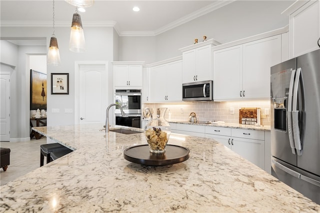 kitchen featuring white cabinetry, sink, appliances with stainless steel finishes, ornamental molding, and hanging light fixtures