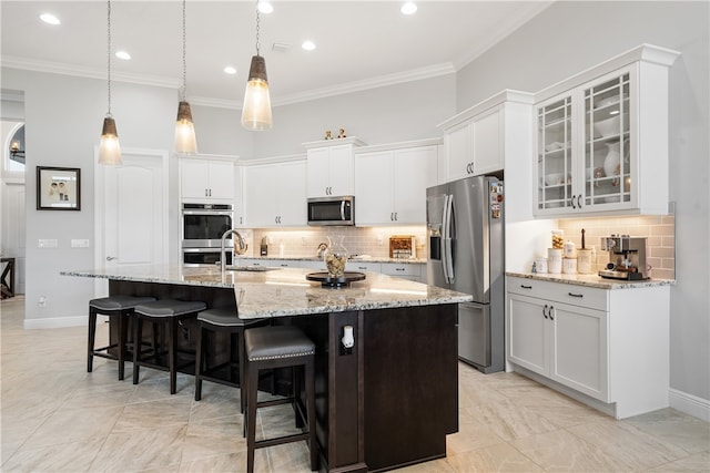 kitchen featuring stainless steel appliances, a center island with sink, and white cabinetry