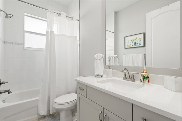 full bathroom featuring shower / tub combo with curtain, vanity, and toilet