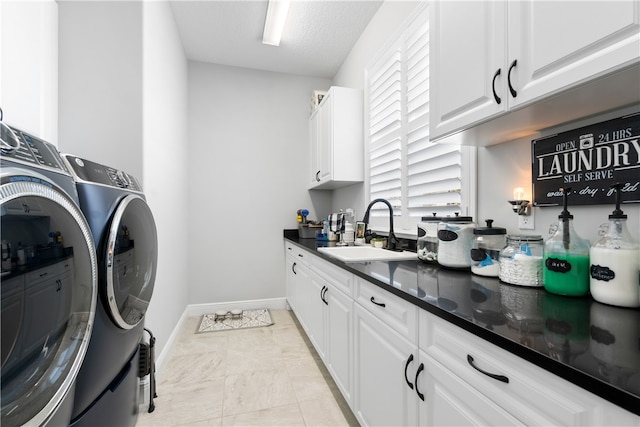 laundry room with cabinets, sink, a textured ceiling, light tile patterned floors, and washing machine and dryer