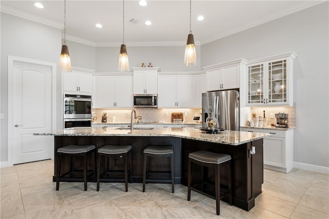 kitchen with sink, white cabinetry, appliances with stainless steel finishes, and a large island