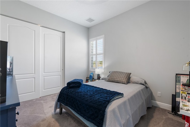 carpeted bedroom with a closet