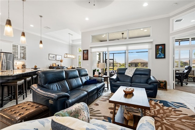 tiled living room featuring sink, ceiling fan, and crown molding