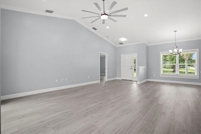 614 Stevenson Ave, Sebastian, FL 32958 - unfurnished living room featuring a chandelier, a ceiling fan, ornamental molding, wood finished floors, and vaulted ceiling