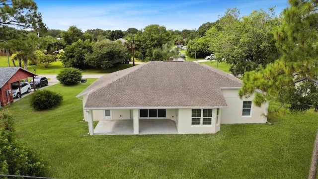 614 Stevenson Ave, Sebastian, FL 32958 - rear view of property with stucco siding, a shingled roof, a patio, and a lawn